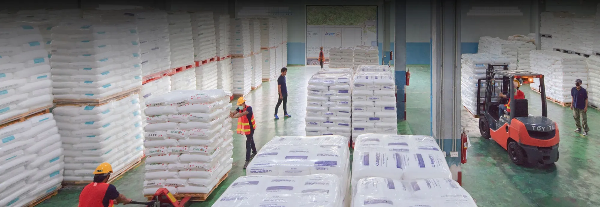 คนกำลังลำเลียงถุงำลาสติกในโรงงาน